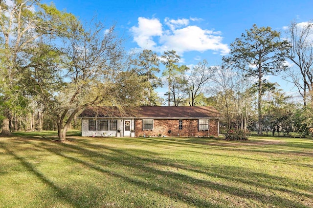 exterior space with a front yard and brick siding