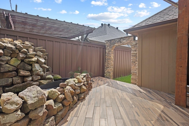 view of patio with a deck and fence
