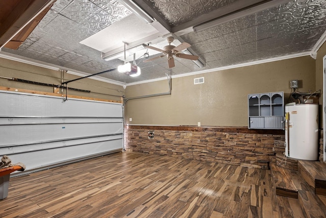 garage featuring water heater, an ornate ceiling, wainscoting, a ceiling fan, and a garage door opener