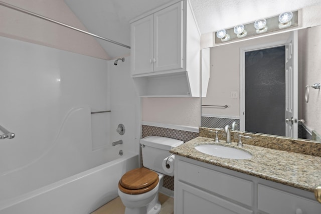 bathroom with vanity, toilet, and  shower combination