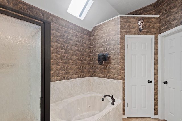 bathroom with vaulted ceiling and a whirlpool tub