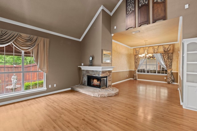 unfurnished living room featuring a chandelier, crown molding, wood finished floors, baseboards, and vaulted ceiling