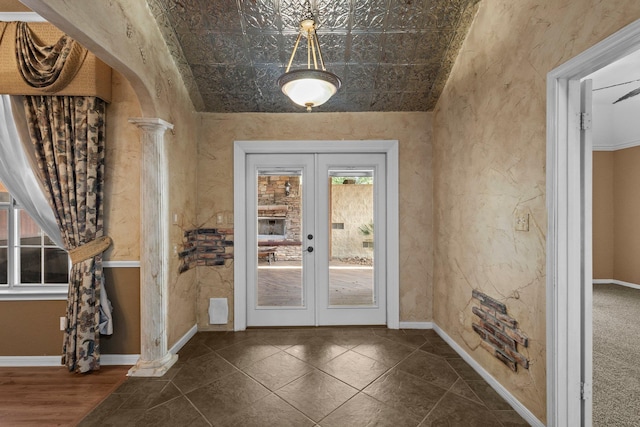 doorway to outside featuring french doors, baseboards, an ornate ceiling, and arched walkways