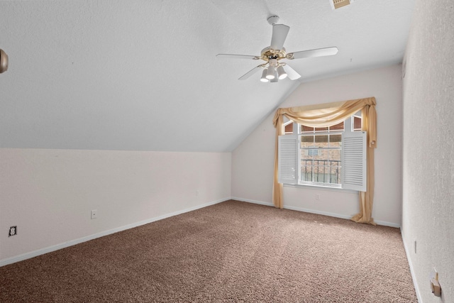 bonus room featuring carpet floors, vaulted ceiling, ceiling fan, and baseboards