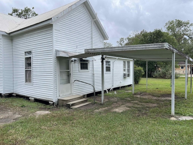 back of property featuring a yard and cooling unit