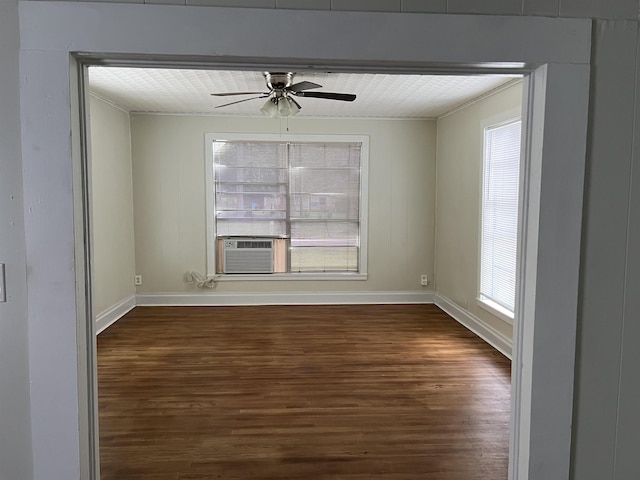 spare room with a wealth of natural light, ceiling fan, dark hardwood / wood-style flooring, and cooling unit