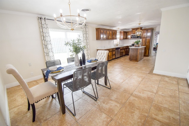 tiled dining room featuring sink, a chandelier, and ornamental molding