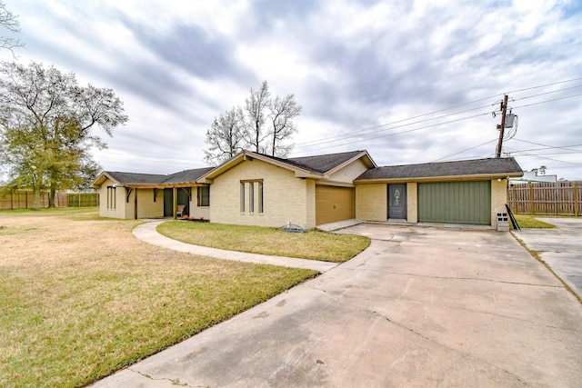 ranch-style house with a garage and a front lawn