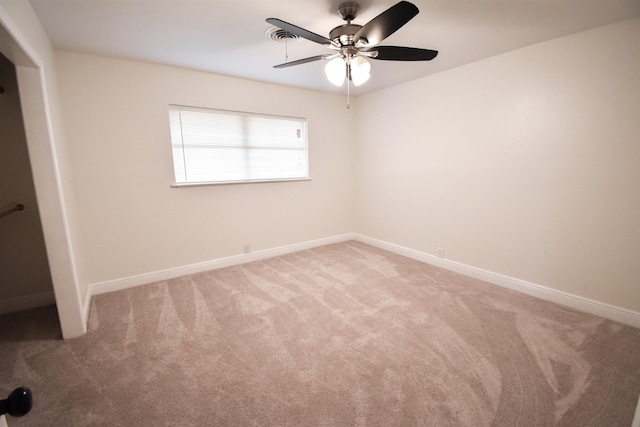 spare room with light colored carpet and ceiling fan