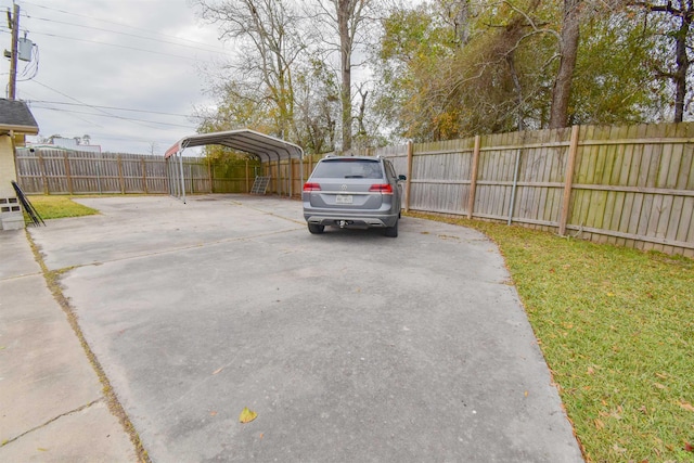 view of vehicle parking featuring a carport and a lawn