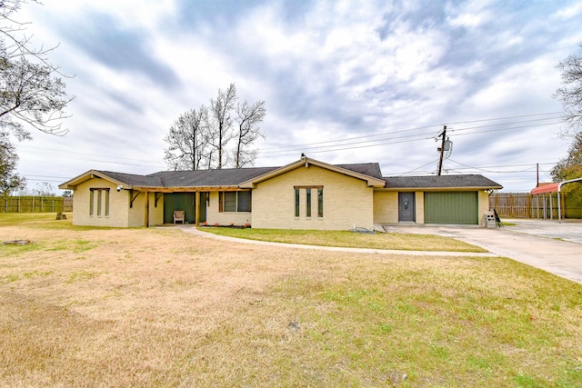 single story home featuring a garage and a front yard