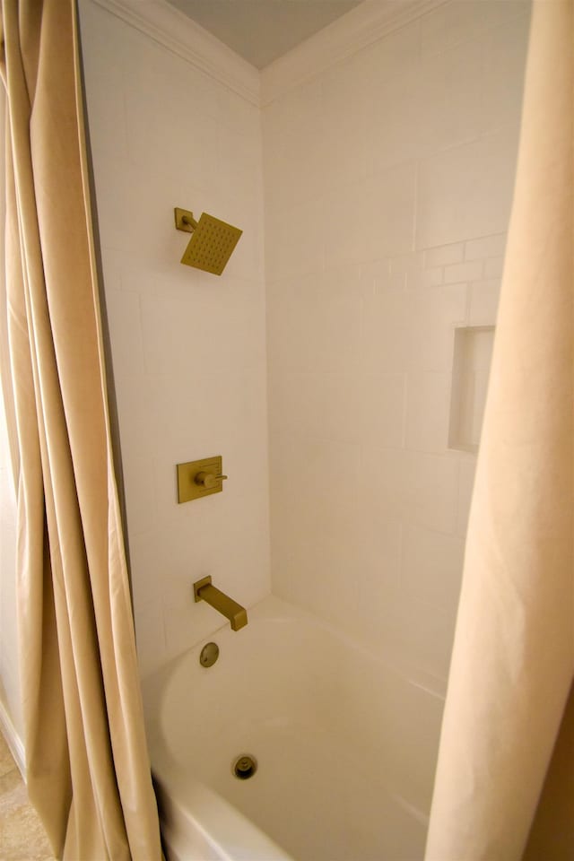 bathroom featuring ornamental molding and shower / tub combo