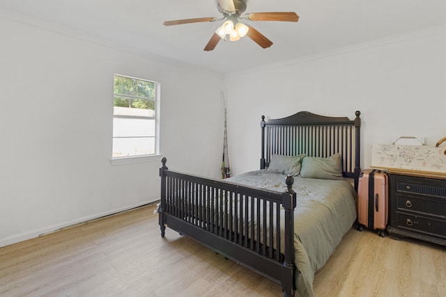 bedroom featuring ceiling fan, ornamental molding, and light wood-type flooring