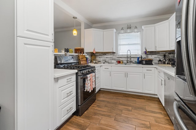 kitchen with white cabinets, decorative light fixtures, sink, and stainless steel appliances