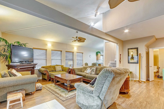 living room with vaulted ceiling with beams, ceiling fan, and light hardwood / wood-style flooring