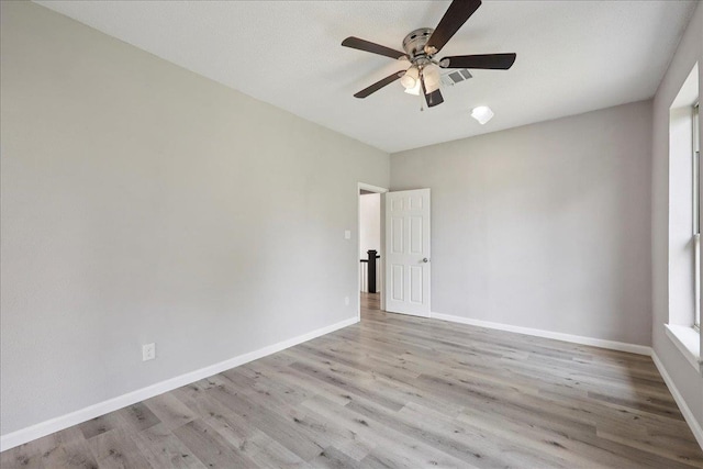 2033 Broadway St, Beaumont, TX 77702 - spare room with wood finished floors, ceiling fan, and baseboards