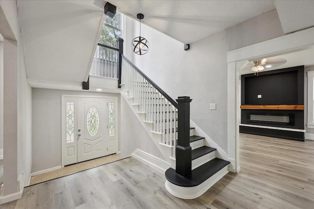 2033 Broadway St, Beaumont, TX 77702 - entryway featuring wood finished floors, baseboards, stairway, and a ceiling fan