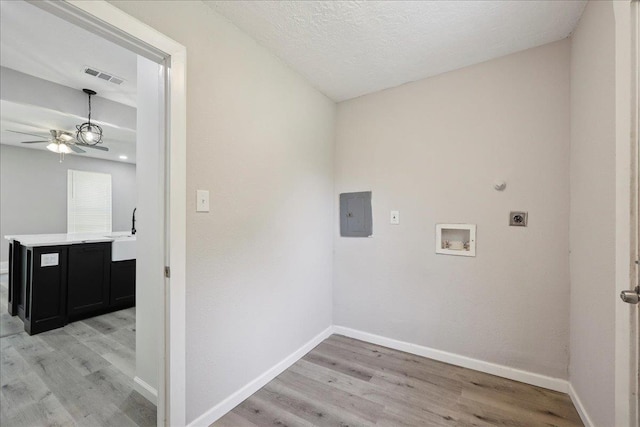 2033 Broadway St, Beaumont, TX 77702 - laundry area featuring hookup for an electric dryer, light wood-type flooring, a ceiling fan, and washer hookup