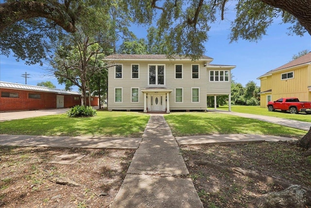 2033 Broadway St, Beaumont, TX 77702 - colonial-style house featuring a front lawn