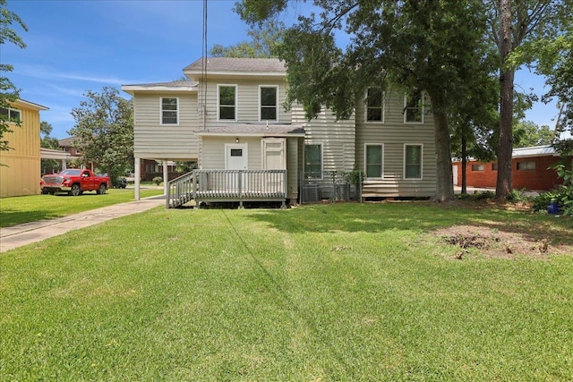 2033 Broadway St, Beaumont, TX 77702 - rear view of property with a yard, a wooden deck, and roof with shingles