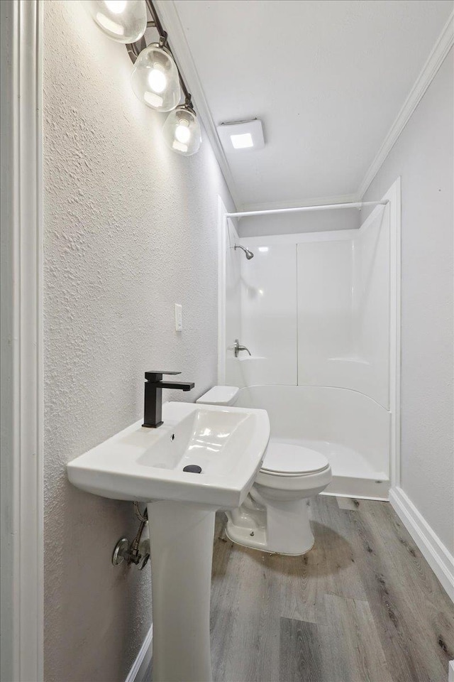 2033 Broadway St, Beaumont, TX 77702 - bathroom featuring wood finished floors, walk in shower, crown molding, a textured wall, and toilet
