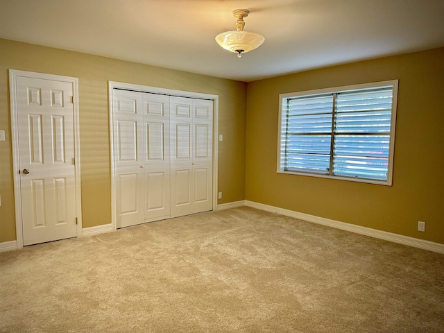 unfurnished bedroom featuring light carpet