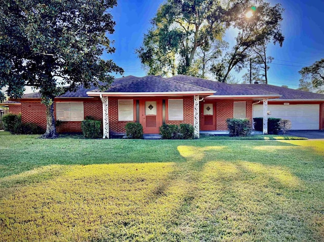 ranch-style house featuring a garage and a front lawn