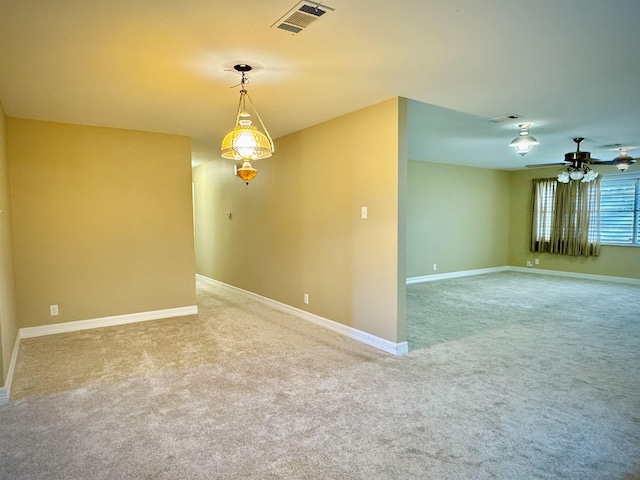 carpeted spare room with ceiling fan