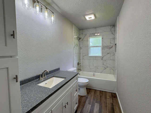 13595 Rolling Hills Dr, Beaumont, TX 77713 - full bath with wood finished floors, vanity, toilet, a textured ceiling, and a textured wall
