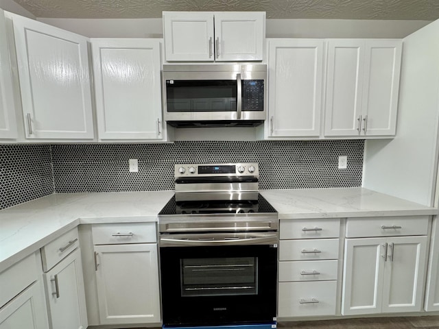 13595 Rolling Hills Dr, Beaumont, TX 77713 - kitchen featuring stainless steel appliances, white cabinets, and backsplash