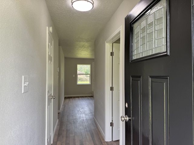 13595 Rolling Hills Dr, Beaumont, TX 77713 - corridor featuring a textured ceiling, wood finished floors, and baseboards