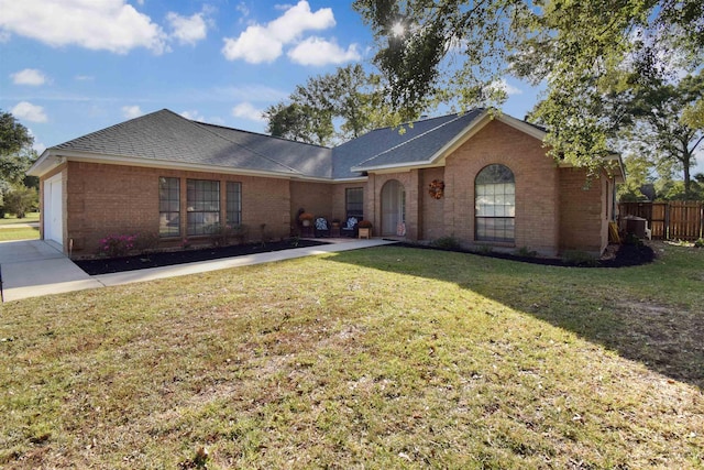 ranch-style home with a front yard and a garage