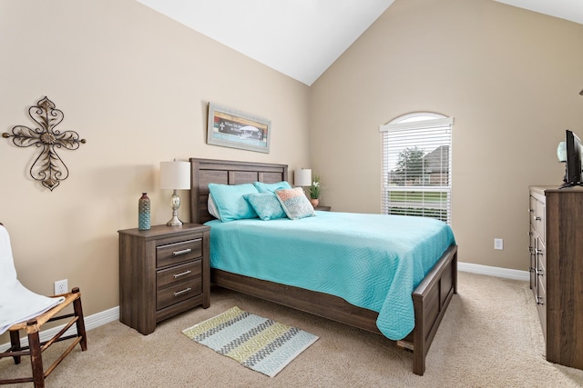 bedroom featuring light carpet and high vaulted ceiling