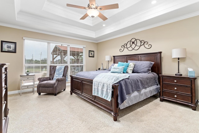 bedroom featuring a tray ceiling, ceiling fan, light colored carpet, and ornamental molding