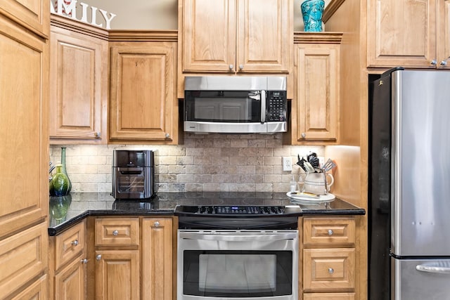 kitchen with dark stone countertops, backsplash, and appliances with stainless steel finishes