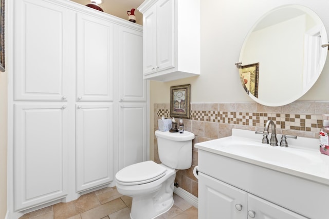 bathroom with tile patterned flooring, vanity, and toilet