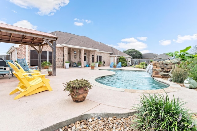 view of swimming pool featuring pool water feature and a patio