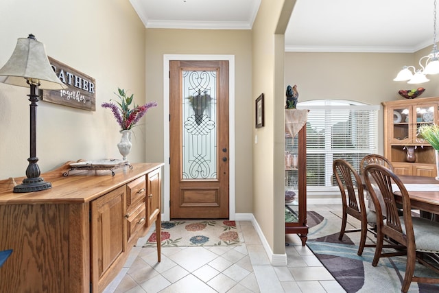 tiled foyer entrance featuring a chandelier and ornamental molding