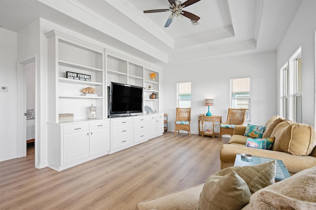 981 S S Gtwy, Crystal Beach, TX 77650 - living area with light wood-style flooring, ceiling fan, baseboards, and a raised ceiling