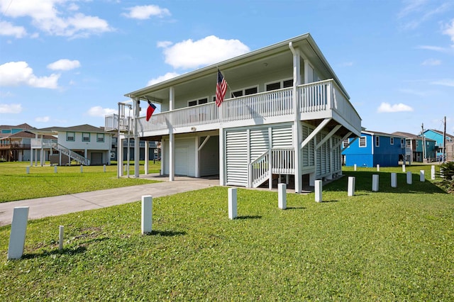 981 S S Gtwy, Crystal Beach, TX 77650 - rear view of property featuring a garage, concrete driveway, a yard, stairway, and a residential view