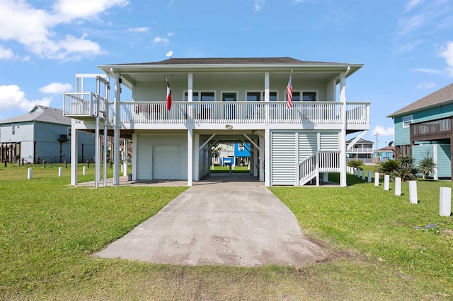 981 S S Gtwy, Crystal Beach, TX 77650 - coastal inspired home with a carport, a garage, concrete driveway, a front lawn, and a porch