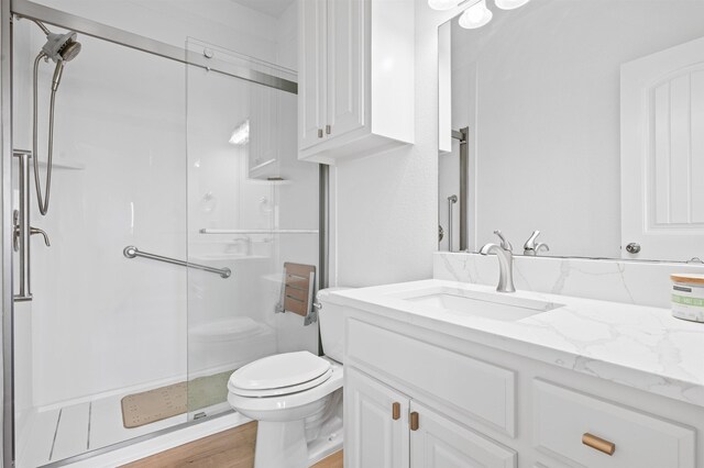 981 S S Gtwy, Crystal Beach, TX 77650 - full bathroom with a stall shower, toilet, vanity, and wood finished floors