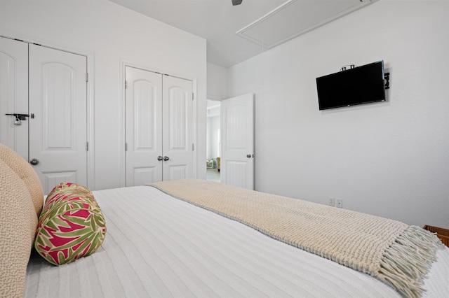 981 S S Gtwy, Crystal Beach, TX 77650 - bedroom featuring attic access, ceiling fan, and two closets