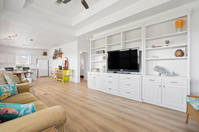 981 S S Gtwy, Crystal Beach, TX 77650 - living room featuring light wood finished floors, ceiling fan, a raised ceiling, and crown molding