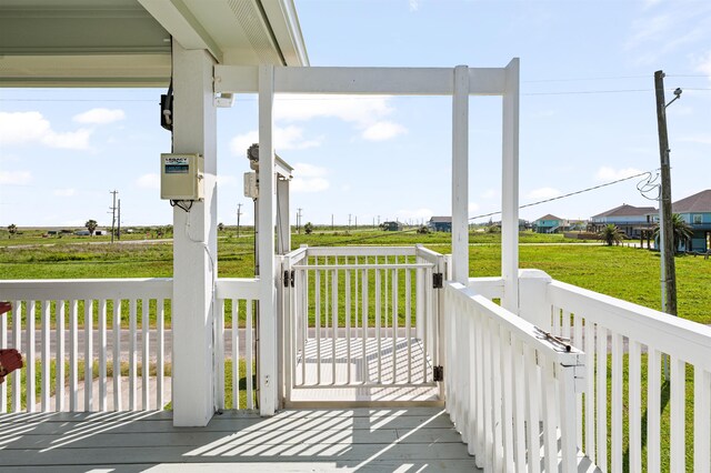 981 S S Gtwy, Crystal Beach, TX 77650 - wooden deck featuring covered porch and a lawn