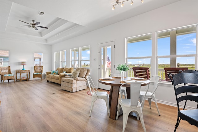 981 S S Gtwy, Crystal Beach, TX 77650 - living room featuring ceiling fan, light wood-style floors, a raised ceiling, baseboards, and ornamental molding