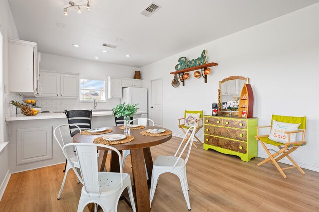 981 S S Gtwy, Crystal Beach, TX 77650 - dining area with light wood-style flooring, baseboards, and recessed lighting