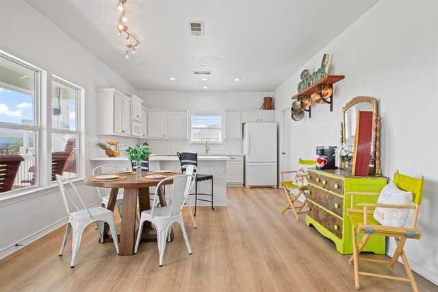 981 S S Gtwy, Crystal Beach, TX 77650 - dining room featuring light wood-style flooring, recessed lighting, and baseboards