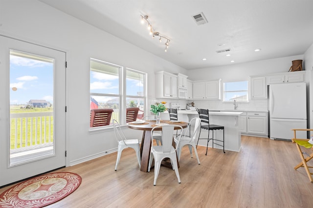 981 S S Gtwy, Crystal Beach, TX 77650 - dining space with light wood-type flooring and recessed lighting