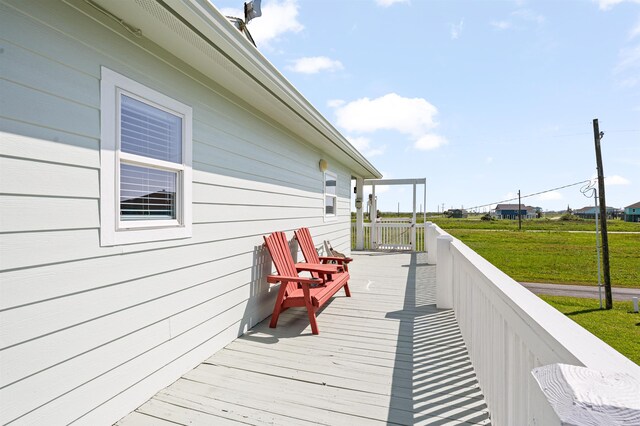 981 S S Gtwy, Crystal Beach, TX 77650 - wooden terrace featuring a lawn